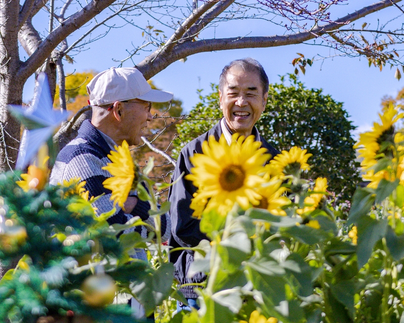 ヒマワリのように爽やかな笑顔の「まちの活性化委員会」メンバーの皆さん
